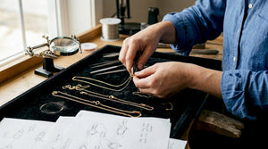 Jeweler arranging gold clasps in studio