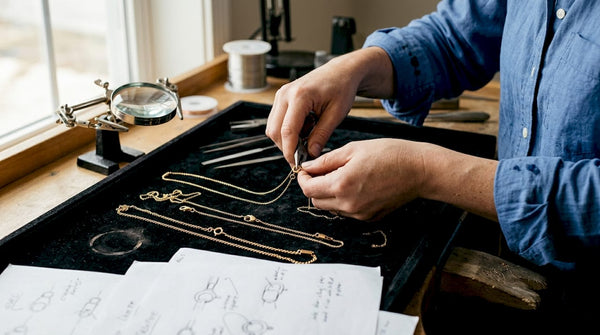 Jeweler arranging gold clasps in studio