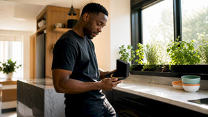 Man opening gold chain gift in living room
