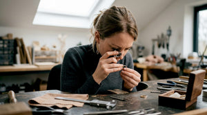 Jeweler inspecting hallmark on gold ring