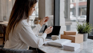 Woman carefully inspecting packaged jewelry at home