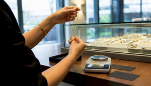 Hand inspecting 14K gold jewelry