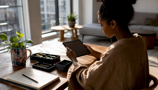 Woman browsing solid gold chains on tablet at home