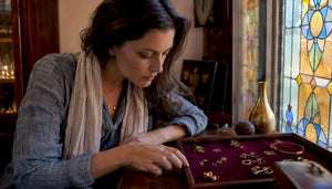 Woman inspecting gold jewelry in boutique