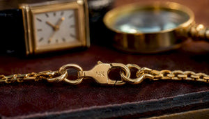 Close-up of gold chain with 14K hallmark stamp