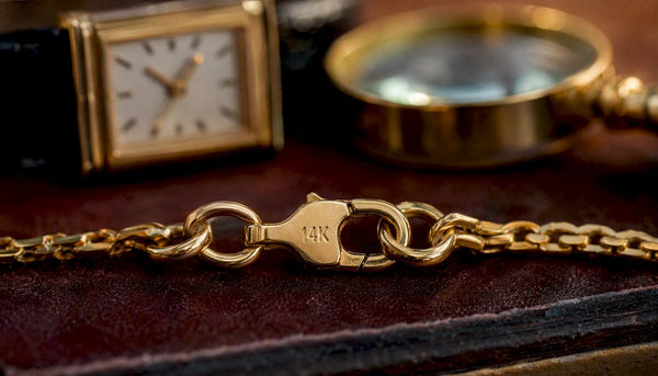 Close-up of gold chain with 14K hallmark stamp