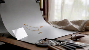 Home gold jewelry photography setup with LED panels and white sweep