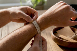 Man's wrist measured with tape